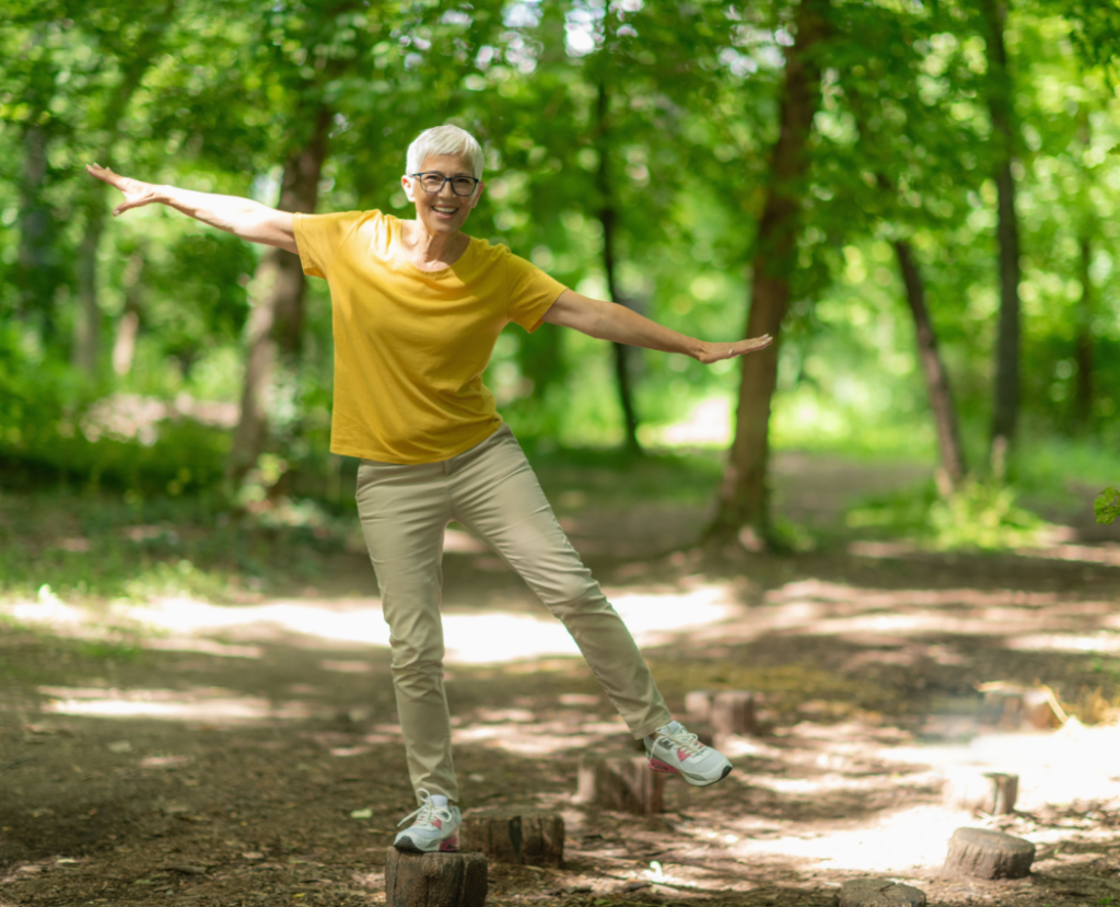 Senior woman doing balance exercises in the park.