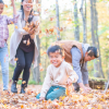 Happy, healthy family enjoys fall leaves in the outdoors